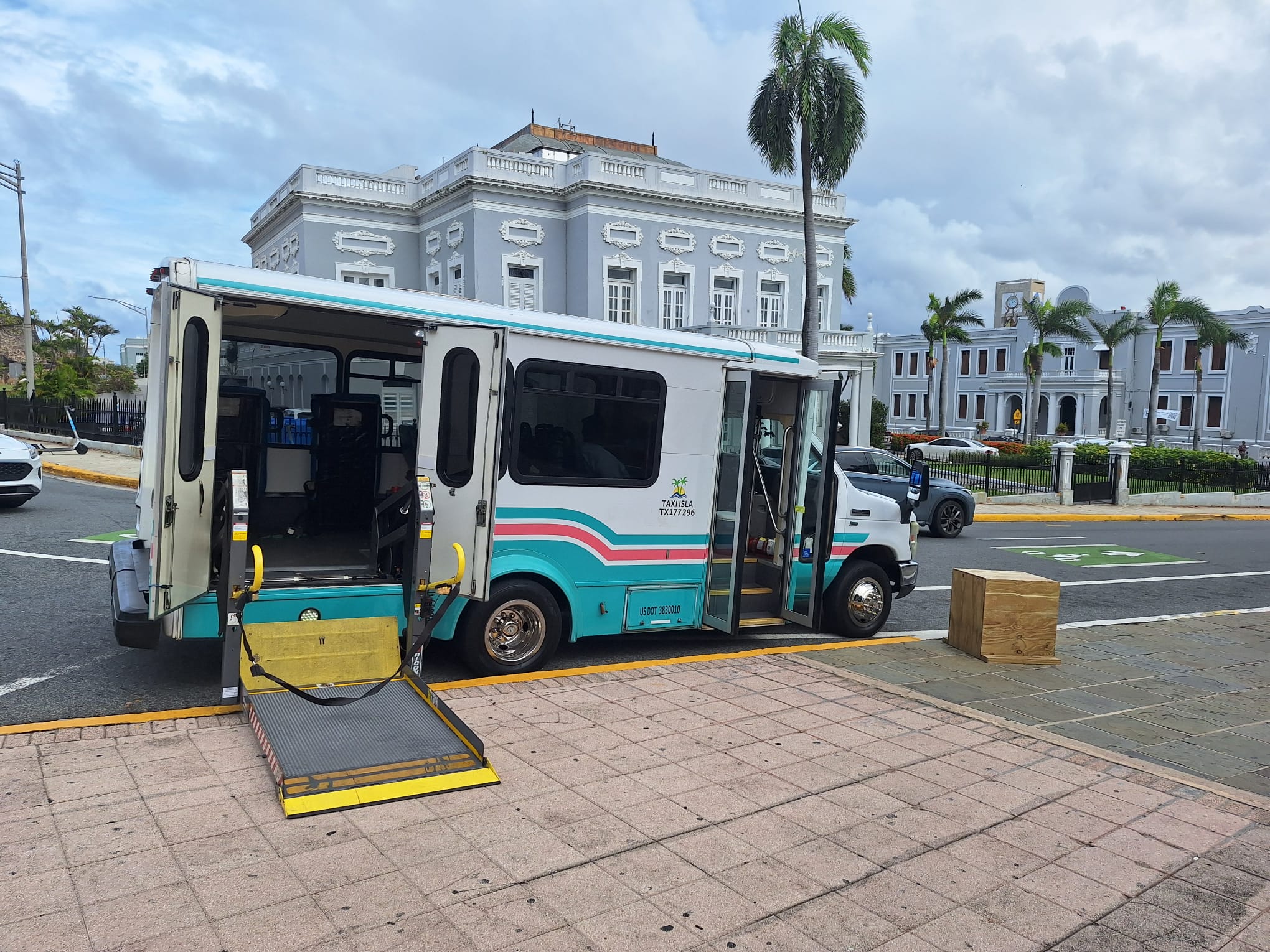 DP Transport wheelchair-accessible van with rear lift platform lowered to the ground in Old San Juan