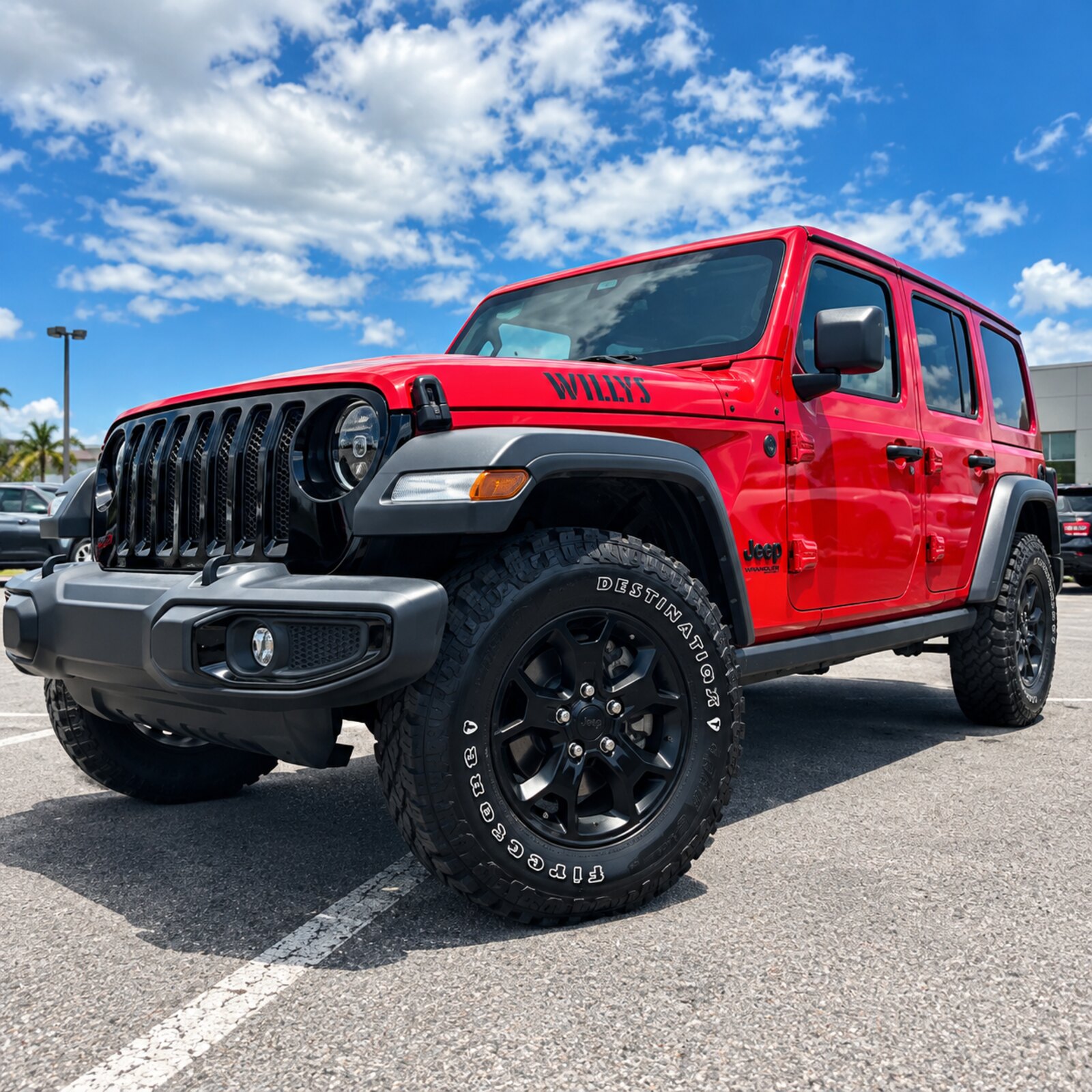 Red Jeep Wrangler Willys on black wheels available for daily rental in Puerto Rico