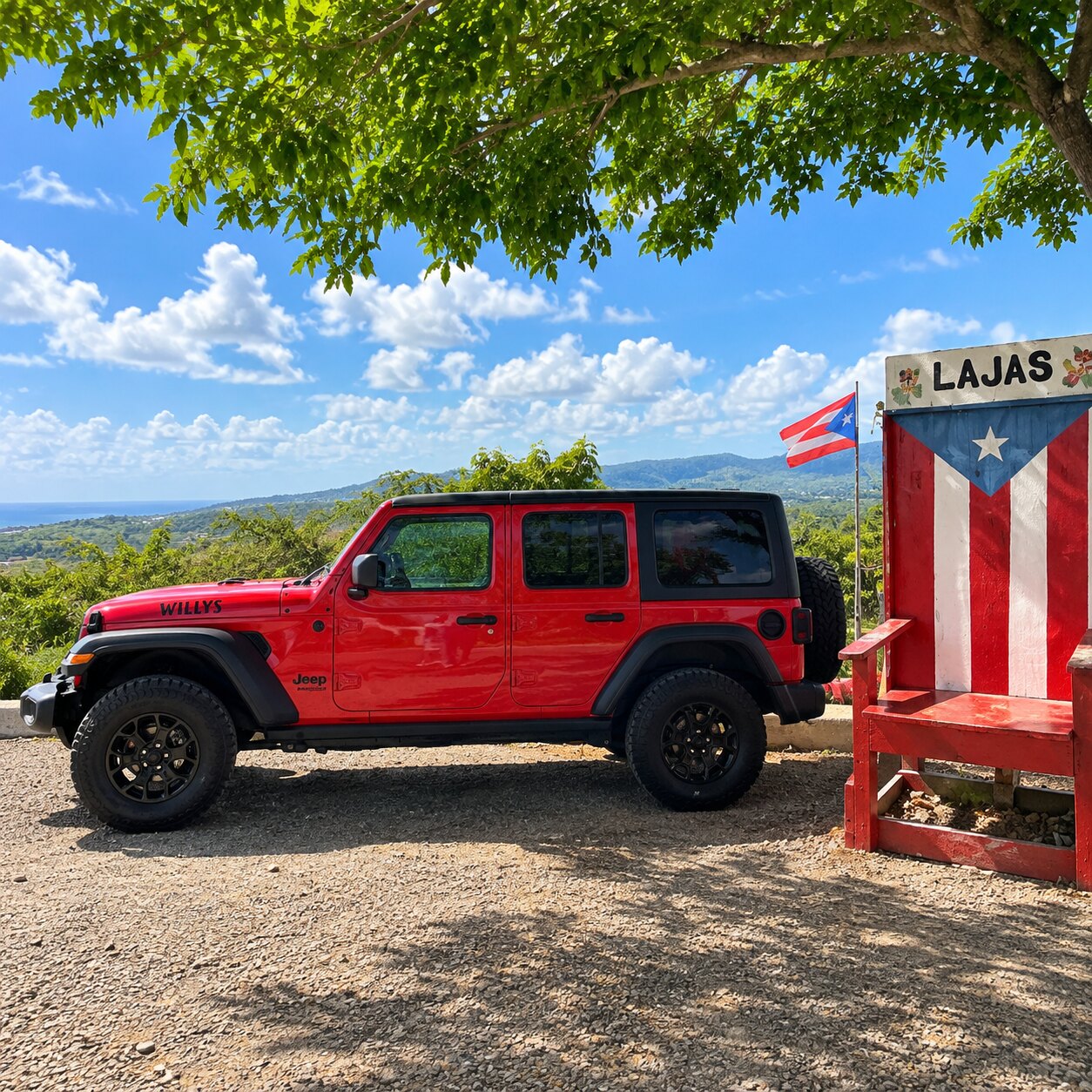 Big Red Jeep Wrangler Willys parked by the Puerto Rican flag bench at a Lajas mountain lookout