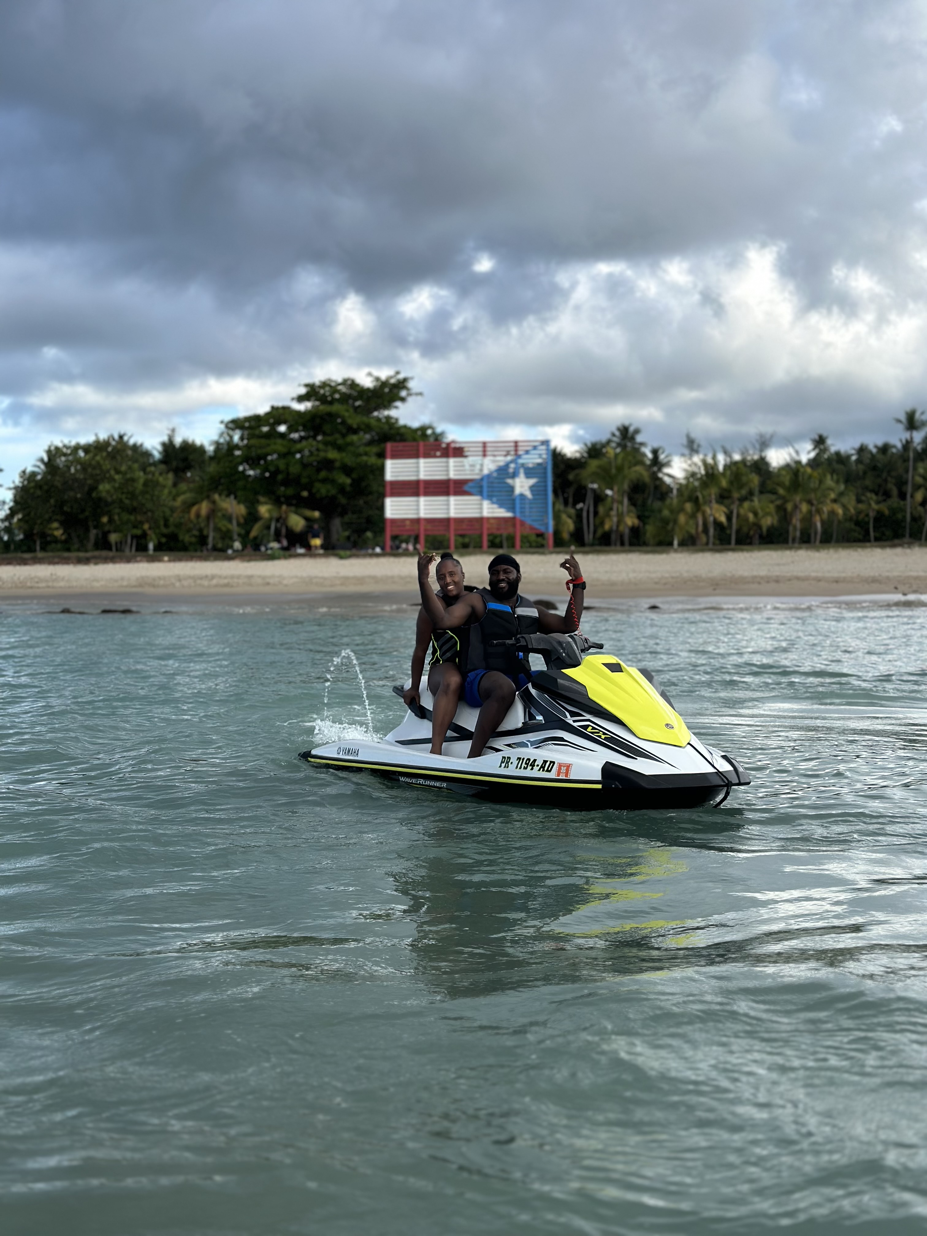 Two riders on a Yamaha jet ski rental near Pine Grove beach in Isla Verde, Puerto Rico