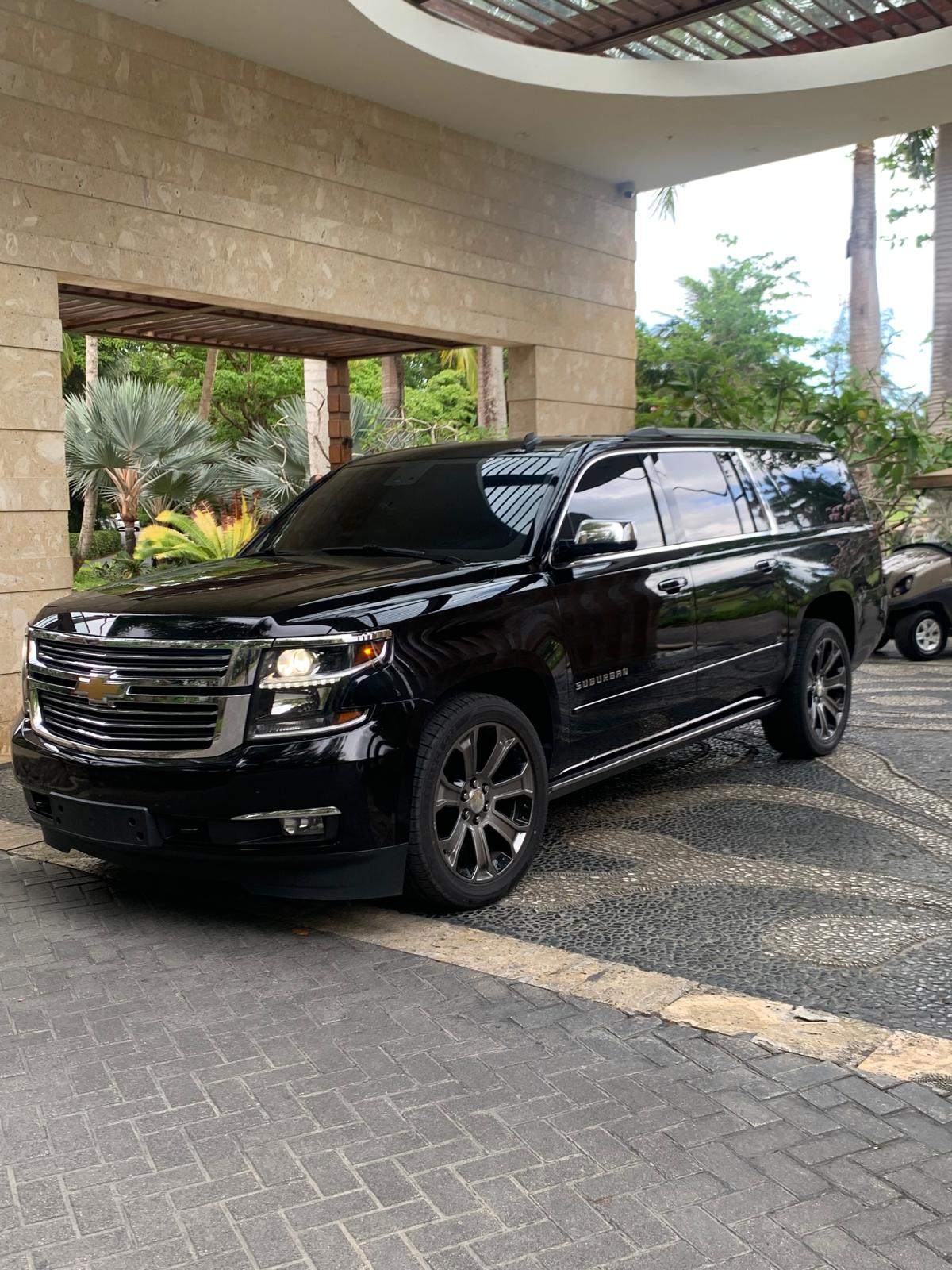 Black Chevrolet Suburban luxury SUV at a Puerto Rico resort entrance